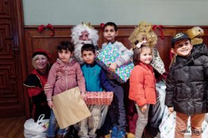 niños y niñas junto a los reyes magos en la fiesta de reyes de la asociación Amigos de la calle.